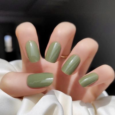 Applied muted olive green gel wraps with a glossy finish, showcasing a chic and understated manicure.