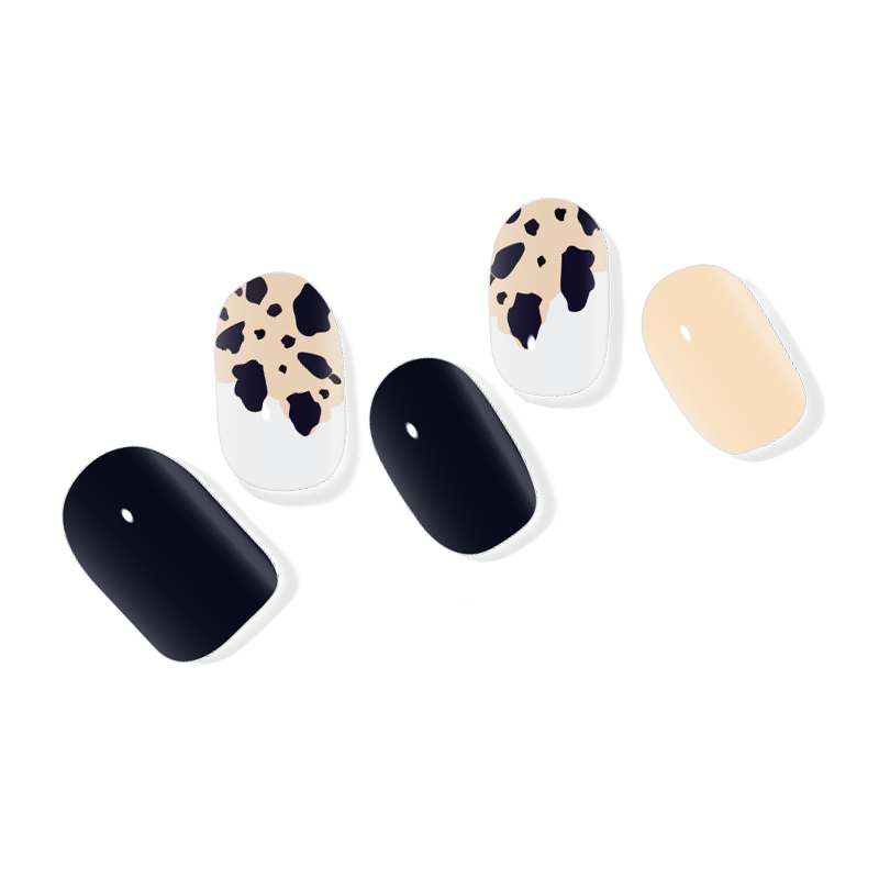 White semi-cured gel nail wraps with black speckled patterns, creating a modern and artistic manicure.