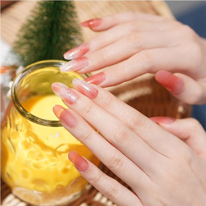 Nails featuring Twinkling Blush gel wraps, presenting a sparkling rose pink manicure.