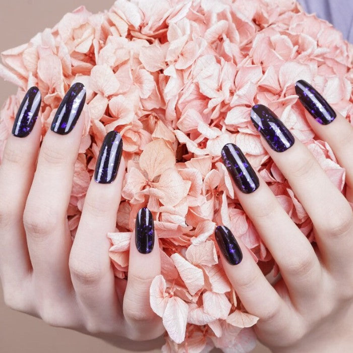 Nails adorned with Cosmic gel wraps paired with metallic silver accent nails for added dimension.