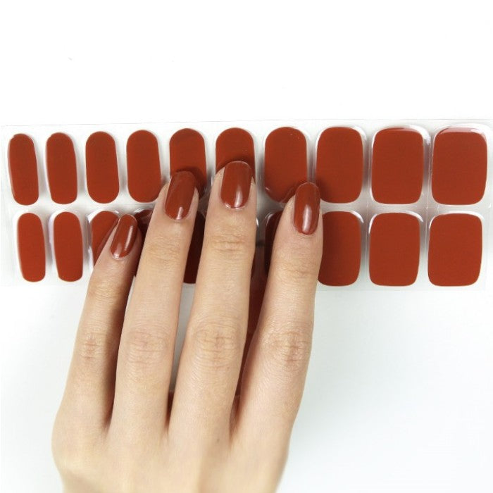 Sticker sheet of warm brown Redwood semi-cured gel wraps, offering a variety of sizes for a precise and effortless at-home manicure.