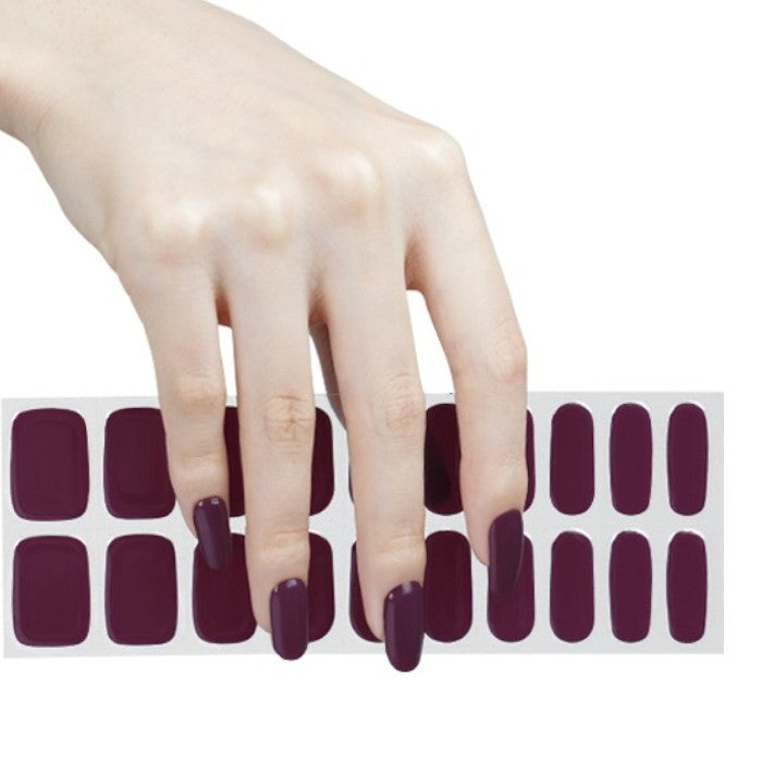 Sticker sheet of deep plum semi-cured gel wraps, featuring various sizes for an easy and long-lasting application.
