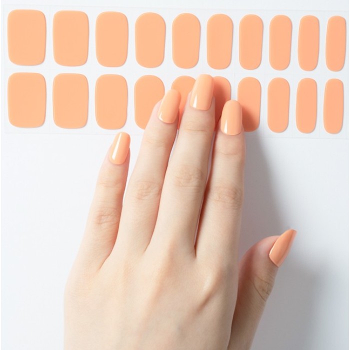Sticker sheet of soft peach semi-cured gel wraps, featuring various sizes for an effortless and flawless application.