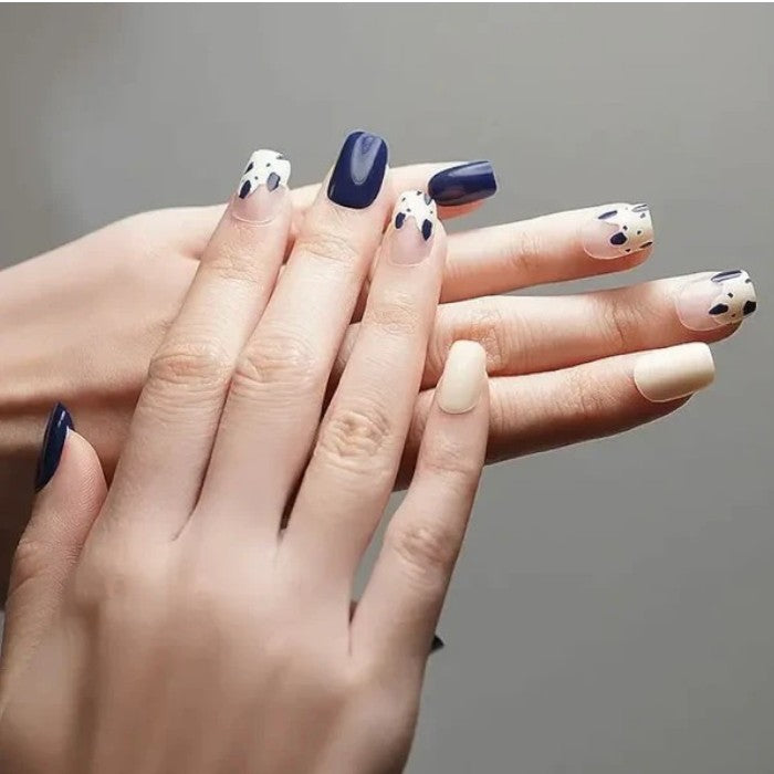 Nails featuring Speckles gel nail wraps, presenting a chic white base with contrasting black speckles.