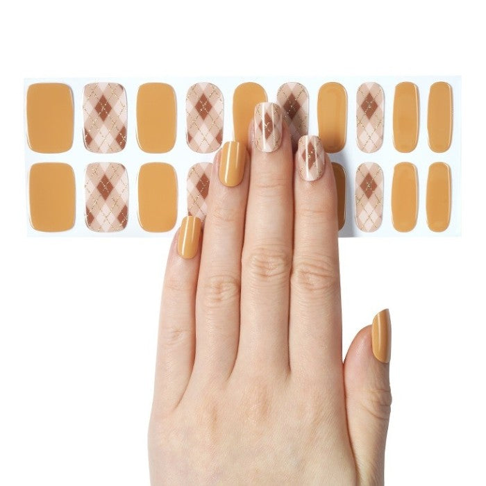 Sticker sheet of Butterscotch semi-cured gel nail wraps in assorted sizes for easy application.