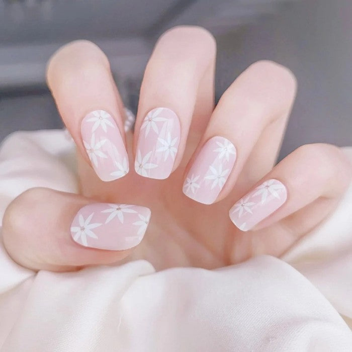Nails featuring Pink Daisies gel wraps, displaying a feminine pink manicure adorned with daisy designs.