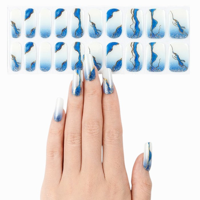 Sticker sheet displaying deep ocean blue gel nail wraps in various sizes.