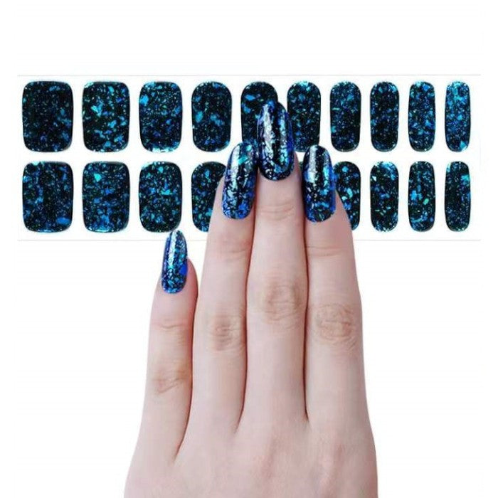 Sticker sheet displaying dark blue gel nail wraps with holographic glitter in assorted sizes.