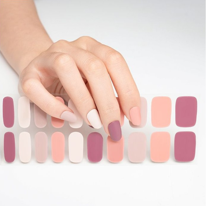 Sticker sheet of pastel pink semi-cured gel wraps, offering various sizes for a seamless and salon-quality application.