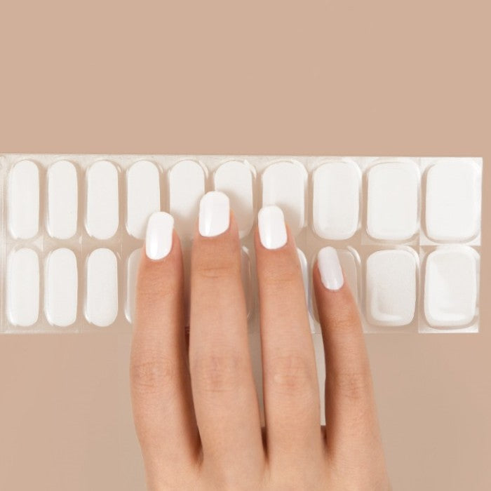 Sticker sheet of pure white semi-cured gel nail wraps with various sizes for a customizable fit. Easy application ensures a professional look at home.