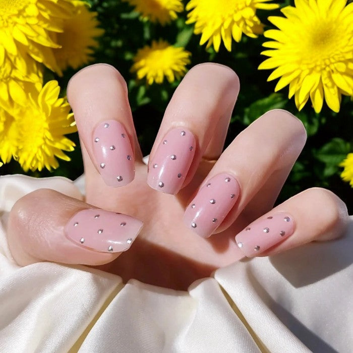 Nails featuring Fairytale gel wraps, showcasing a delicate pastel pink manicure with a hint of shimmer.