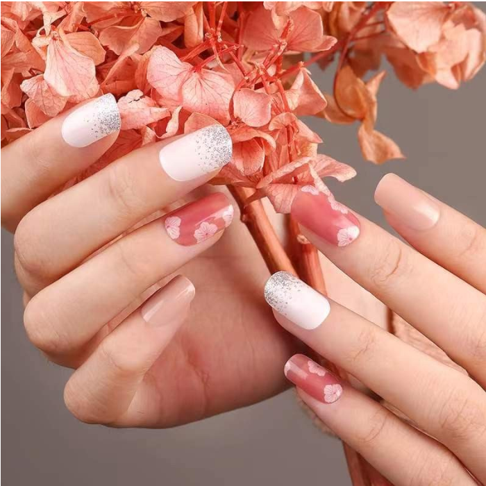 Hands showcasing Camellia gel nail wraps, offering a feminine and elegant pink manicure.